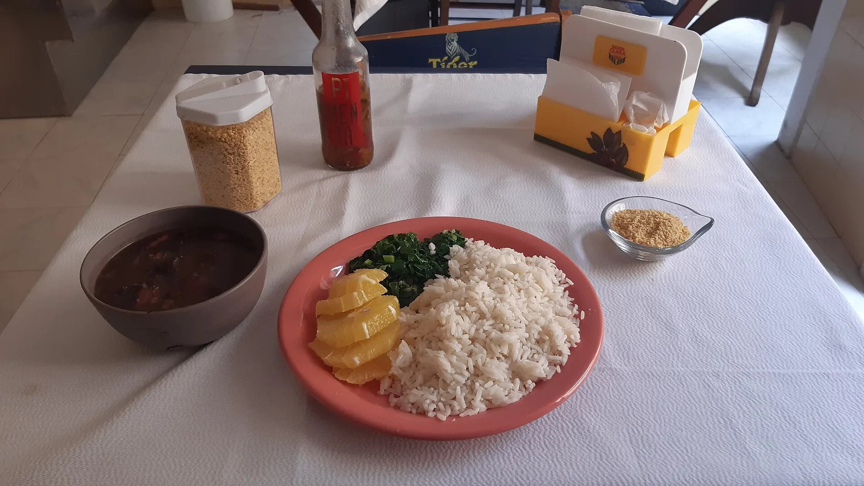 Feijoada, Brazil's national dish, served with rice, greens, farofa and orange